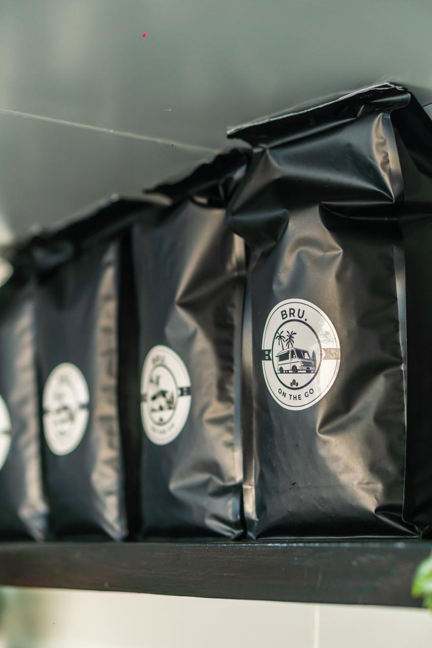 BRU. branded coffee bean bags lined up on a shelf