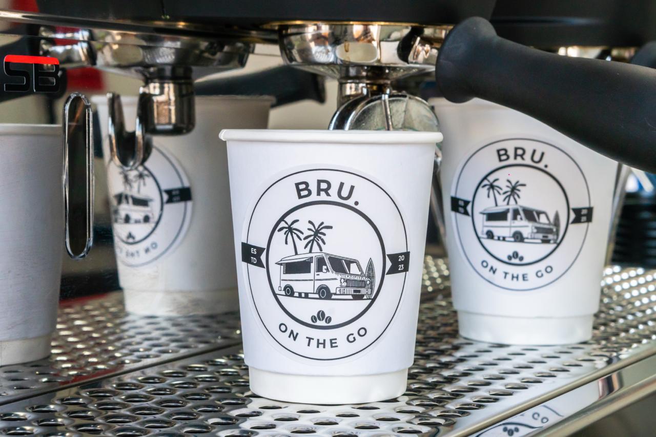 BRU. On The Go branded coffee cup on espresso machine